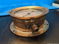 Front angled view showing the dial face with pressure readings and brass casing.