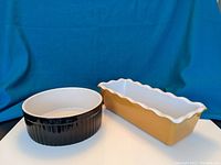 Photo of the two ceramic cookware pieces side by side showing the souffle dish and the ruffled loaf pan.