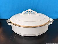 White covered serving dish tureen from Myott & Son with lid on, showing elegant gold band decoration and handle details.