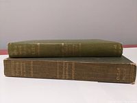 Side view of both books stacked showing spine titles which identify them as Plato's Socratic Dialogues and Aristotle's Politics.