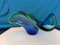 Side angled view showing the smooth curved edges and coloration gradation of blue to green.