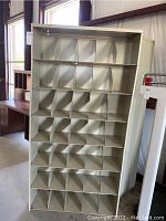 Front view of the metal file cabinet with multiple compartments.