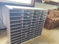 Front view showing multiple horizontal compartments in a laminated frame.