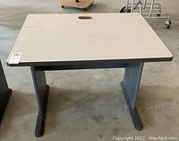 View of laminate side table showing front legs and cut-out handle on surface