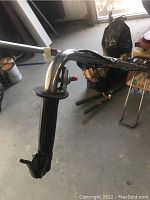 Close-up of tiller handle, throttle control and cable