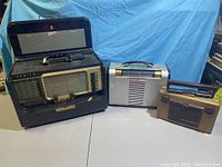 Overview photo of 3 vintage radios showing size and style differences