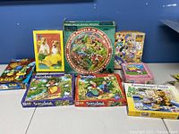 Wide view of 8 children's jigsaw puzzles featuring Disney and Looney Tunes characters along with storybook themes and animal illustrations.