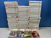 Stack of 76 paperback romance novels in the LOVE INSPIRED series, showing spines with titles and authors for identification.