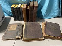 Books arranged on a table showing front covers and bindings, demonstrating the variety and condition of the collection