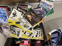 Box filled with various theater Playbills, showing diverse cover artwork and titles, with Playbill branding visible on many covers.
