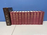 Photo showing the complete set of 15 hardcover books including The Complete Works and multiple volumes of The Guild Shakespeare series arranged upright.