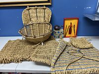 Photo showing five hand-woven bamboo bags and baskets of different sizes, shapes, and weaving patterns laid out on a table.