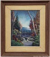 Frontal view of the painting fully framed, showing the river waterfall scene with trees in autumn colors and mountains in the background.