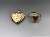 Heart locket and matching ring side by side on grey background