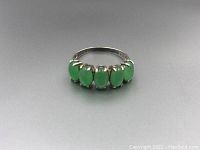 Front view showing six oval green jade stones set in sterling silver band.