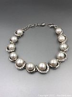 Front angle view of the pearl sterling silver bracelet showing 12 pearls and stone embellishments.