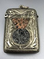 Front view showing detailed thistle engraving and two types of inset stone mosaics (red and gray)