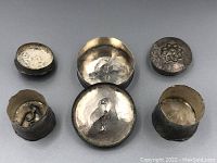 Top and inside views of the three silver boxes showing lids removed and silver marks inside.