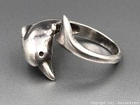 Side view showing dolphin head and open ring design.