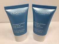 Two sealed blue tubes of Clarins Paris HydraQuench Cream-Mask with white caps and white text.