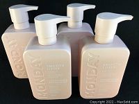 Four matte blush-pink MONDAY Smooth conditioner bottles with pump tops arranged side by side showing front packaging.