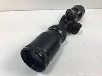 View of the scope showing the front lens and marked distance adjustment dial on the side, highlighting condition and design details.