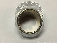 Top view of the genuine SWAROVSKI Nirvana ring showing clear white faceted crystal and silver rhodium band inside with slight wear marks.