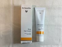 Front view of Dr. Hauschka Rose Day Cream tube and its box, white with orange accents, 30ml size.