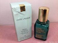 Photo showing the product bottle next to its box with front labels visible.