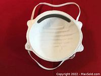 White FFP2 face mask showing inside with nose foam strip and elastic bands