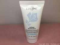 Front view of Lancôme Paris 'Crème Radiance' 50 mL cleanser tube, showing brand, product name, and floral design.