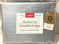 Front of the sealed sheet set packaging showing brand, size, thread count, and material information along with organic cotton certification tag.
