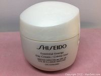 Front view of new Shiseido Essential Energy Day Cream 50mL jar with SPF 20, showing product name and brand.