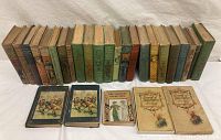 Overview showing 25 assorted 19th century story books in varied colors and conditions with several illustrated covers facing forward.