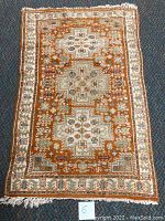 Full view of the Oriental scatter rug showing overall pattern and color scheme