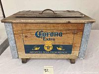 Front view of wooden cooler with Corona Extra branding and metal corner reinforcements.