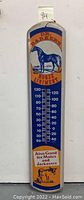 Full view of the vintage Dr. Barker's Horse Liniment thermometer tin sign showing the horse illustration and thermometer scale.