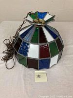 Full side view of the stained glass slag hanging shade with visible metal chain and multi-color glass panels.