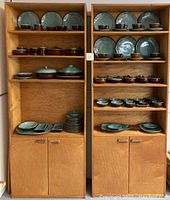 Wide overview of two cabinets displaying entire stoneware set