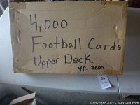 Closed cardboard box labelled with handwritten text: '4,000 Football Cards Upper Deck yr. 2000'