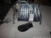 Full view of the stainless steel Rival meat slicer with black plastic food pusher in front