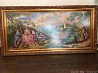 Full view of the framed crochet knit painting showing the entire pastoral scene with figures by a lake.