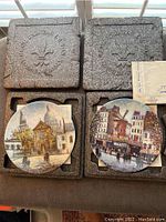 Two Louis Dali French decorative plates in original foam packaging, showing the full lot.