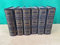 Full set of six books showing spines with volume numbers and gold ornamentation.