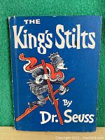 Front cover of The King's Stilts in blue with king on stilts illustration and Dr. Seuss name