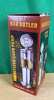 Bar Butler Liquor Pump model box showing the full device image and branding on a green background, upright box view with logo and product depiction.