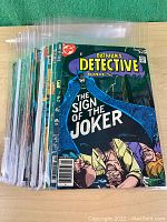 Stack of 33 Detective Comics issues in protective sleeves, front cover of issue #359 visible