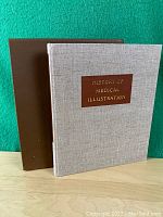 Book with beige cloth cover and brown slipcase, title visible on front cover label.