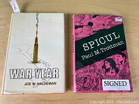 Two hardcover books with dust jackets: 'War Year' and 'Spicul'.