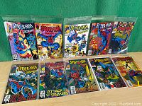 Full set of ten Spider-Man 2099 comic books displayed with covers visible inside protective plastic sleeves, positioned on a flat surface with green background.
